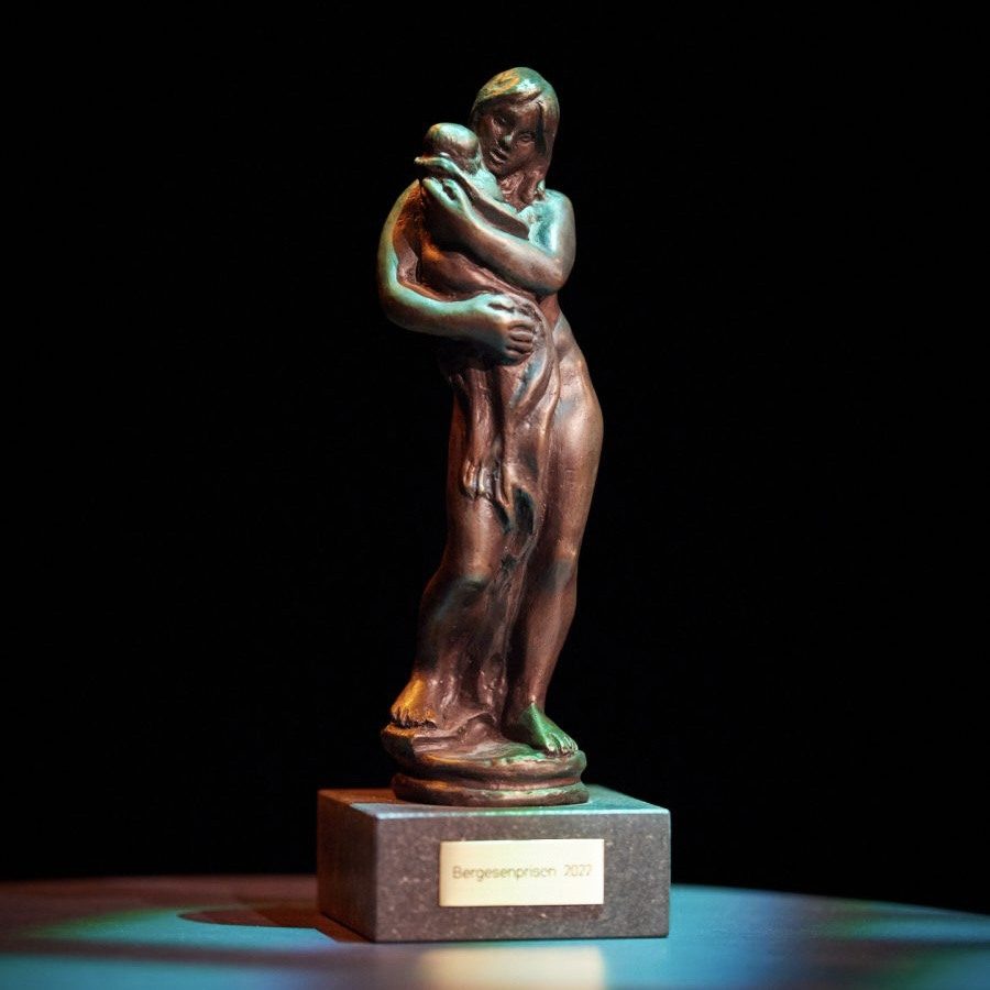 Fotografi av statuett i bronse som forestiller en mor som holder et barn